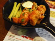 An order of "boneless chicken wings" is shown at a restaurant in Willow Grove, Pa., Wednesday, Feb. 8, 2023. With the Super Bowl at hand, behold the cheerful untruth that has been perpetrated upon (and generally with the blessing of) the chicken-consuming citizens of the United States on menus across the land: a "boneless wing" that isn't a wing at all.