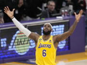 Los Angeles Lakers forward LeBron James celebrates after scoring to pass Kareem Abdul-Jabbar to become the NBA's all-time leading scorer during the second half of an NBA basketball game against the Oklahoma City Thunder Tuesday, Feb. 7, 2023, in Los Angeles. (AP Photo/Mark J.