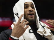 Portland Trail Blazers guard Gary Payton II wears a towel over his head during the second half of an NBA basketball game against the Chicago Bulls, Saturday, Feb. 4, 2023, in Chicago.