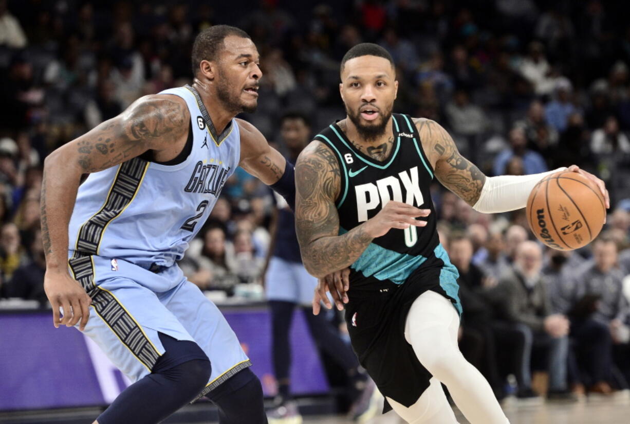 Portland Trail Blazers guard Damian Lillard (0) handles the ball against Memphis Grizzlies forward Xavier Tillman (2) in the first half of an NBA basketball game Wednesday, Feb. 1, 2023, in Memphis, Tenn.