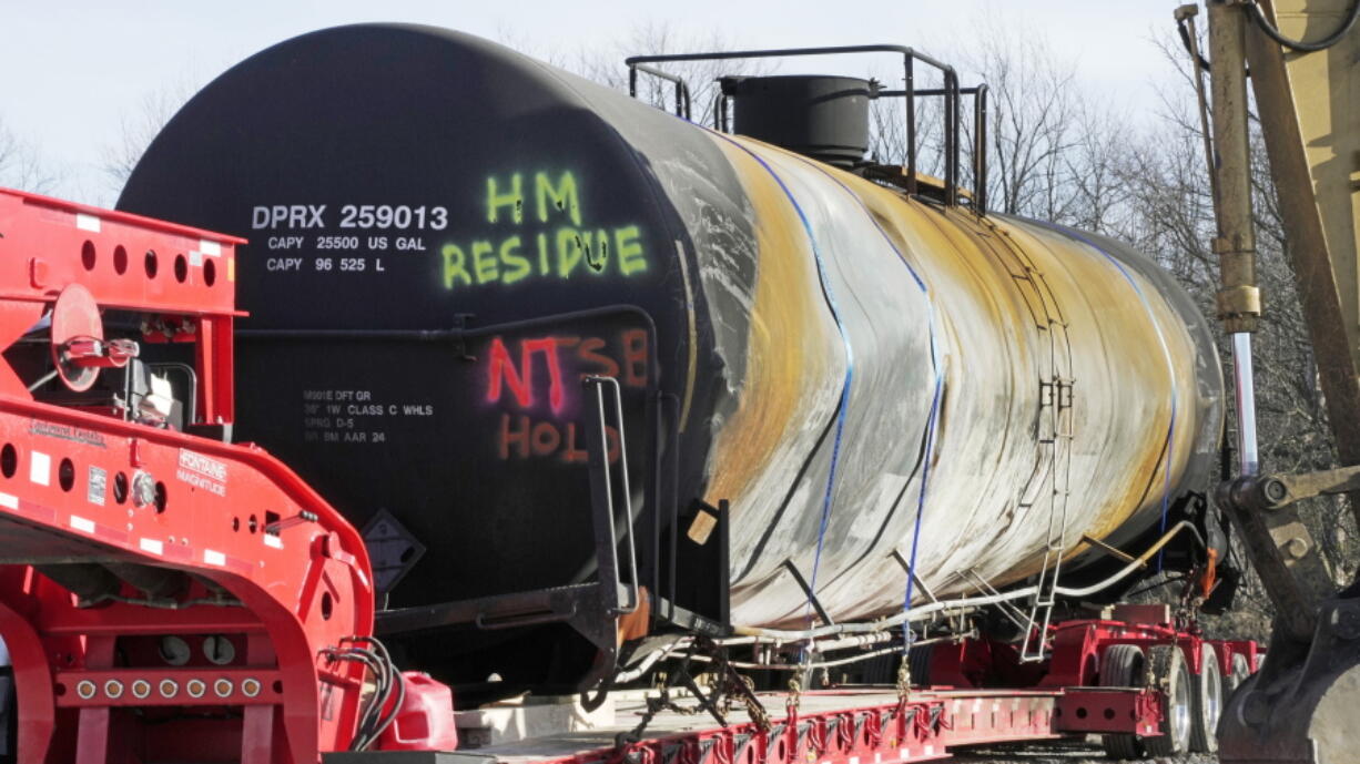 A tank car sits on a trailer as the cleanup of portions of a Norfolk Southern freight train that derailed over a week ago continues in East Palestine, Ohio, Wednesday, Feb. 15, 2023. (AP Photo/Gene J.