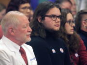 Adam Kellogg, center, a University of Kansas student and transgender man, follows a Kansas Senate health committee hearing on legislation aimed at preventing gender-affirming care for minors, Tuesday, Feb. 14, 2023, at the Statehouse in Topeka, Kan. The Republican-controlled Kansas Legislature is also considering a measure to define male and female in state law in such a way that it could prevent transgender men and women from changing their driver's licenses and birth certificates.