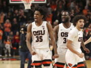 Oregon State's Glenn Taylor Jr., left, Rodrigue Andela, center, and Jordan Pope, right, celebrate after their win over Southern California in an NCAA college basketball game in Corvallis, Ore., Saturday, Feb. 11, 2023.