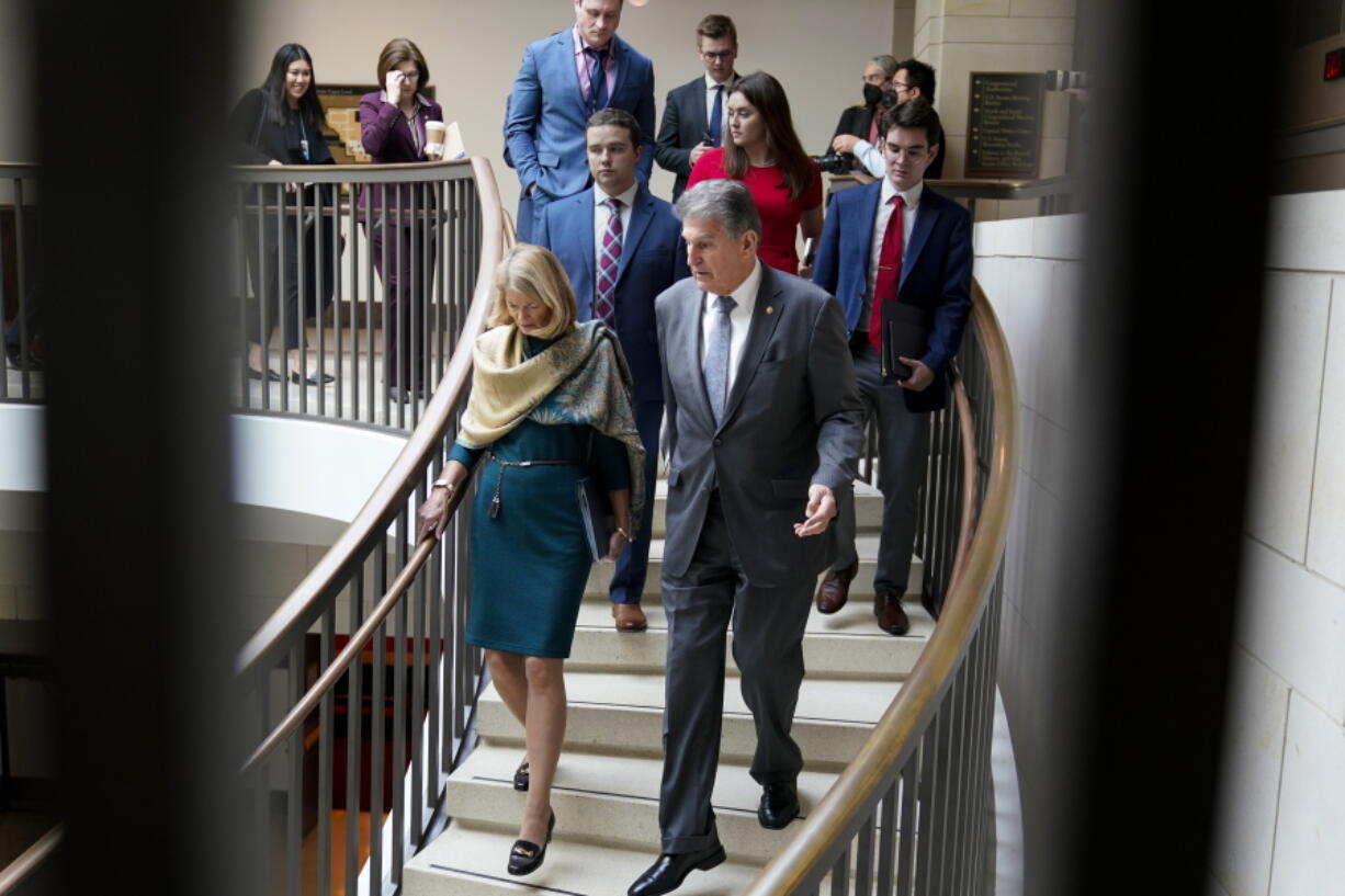 Sen. Lisa Murkowski, R-Alaska, left, and Sen. Joe Manchin, D-W.Va., head to a secure underground facility as lawmakers and intelligence advisers arrive for a closed briefing on the Chinese surveillance balloon that flew over the United States recently, at the Capitol in Washington, Thursday, Feb. 9, 2023. (AP Photo/J.