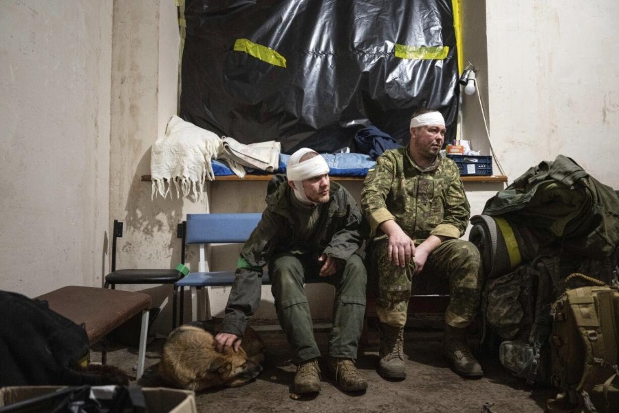 Ukrainian servicemen who were wounded at the battlefield wait to leave the field hospital near Bakhmut, Ukraine, Sunday, Feb. 26, 2023.