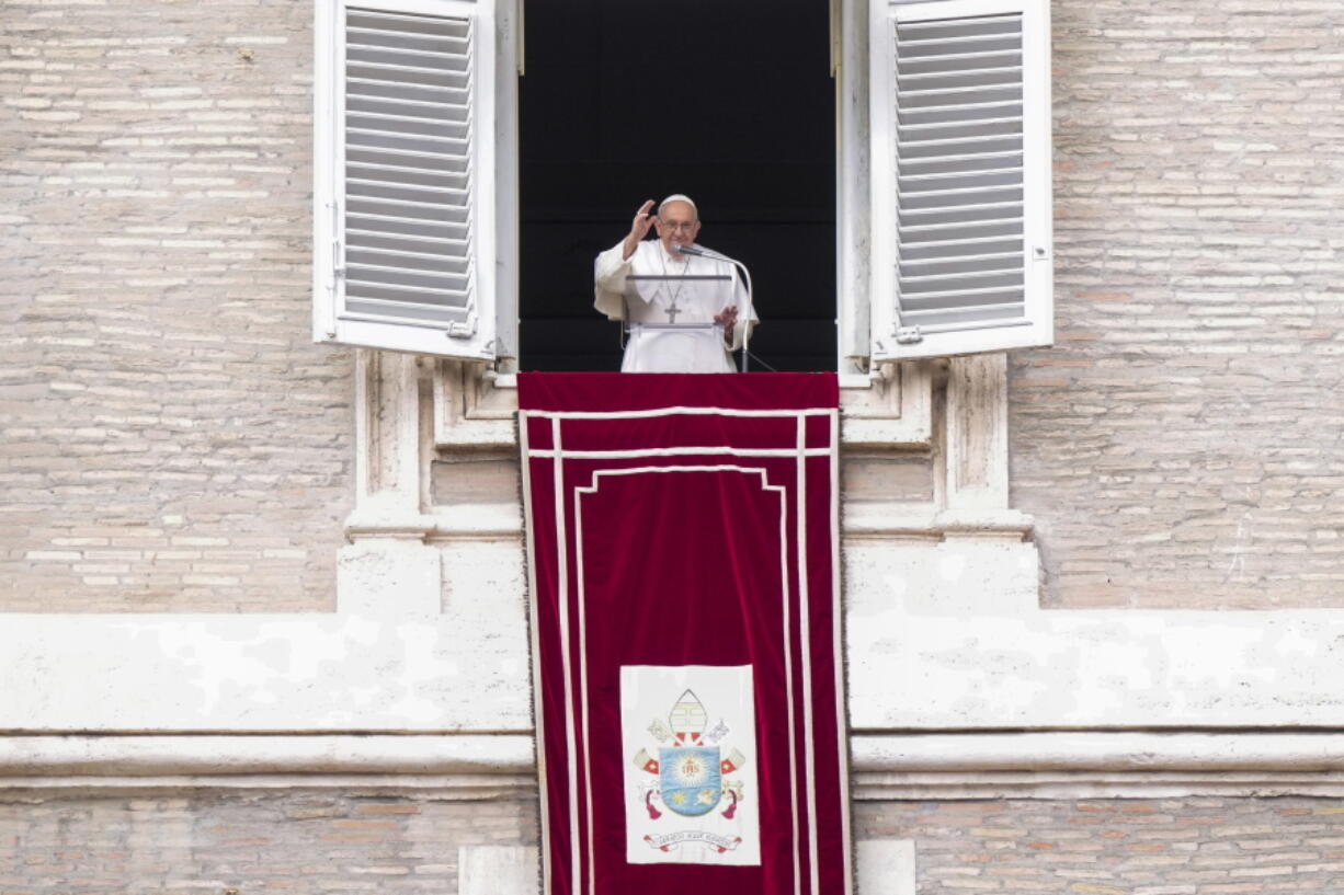 Pope Francis delivers his blessing as he recites the Angelus noon prayer from the window of his studio overlooking St. Peter's Square, at the Vatican, Sunday, Feb. 26, 2023.