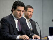 FILE -- In this April 28, 2016 file photo, Tommaso Di Ruzza, then director of the Vatican Financial Information Authority, left, flanked by Rene Brulhart, then president of the AIF. An Italian journalist on Wednesday deflated an accusation in the Vatican's sprawling financial trial, as he disputed Vatican prosecutors' claims about the source of a document concerning the Vatican's 350 million euro investment in a London property. Prosecutors had accused Di Ruzza of having given the journalist a copy of a contract related to the London deal, alleging a violation of Vatican confidentiality laws.