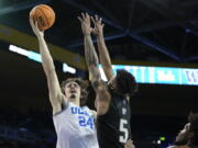 UCLA guard Jaime Jaquez Jr. (24) shoots against Washington guard Jamal Bey (5) during the second half of an NCAA college basketball game in Los Angeles, Thursday, Feb. 2, 2023.