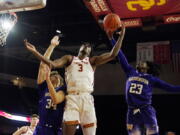 Southern California forward VIncent Iwuchukwu (3) works for a rebound between Washington center Braxton Meah (34) and guard Keyon Menifield (23) during the second half of an NCAA college basketball game Saturday, Feb. 4, 2023, in Los Angeles.