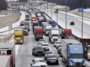 Traffic sits at a standstill along westbound I-20 near Cedar Ridge Drive and Loop 408 in Dallas, Tuesday, Jan. 31, 2023. Several vehicles, including semi-trucks, were unable to make it up a hill causing traffic to stop.