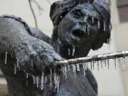 Icicles hang from the Angelina Eberly statue in downtown Austin, Texas, during a winter storm on Wednesday, Feb. 1, 2023.