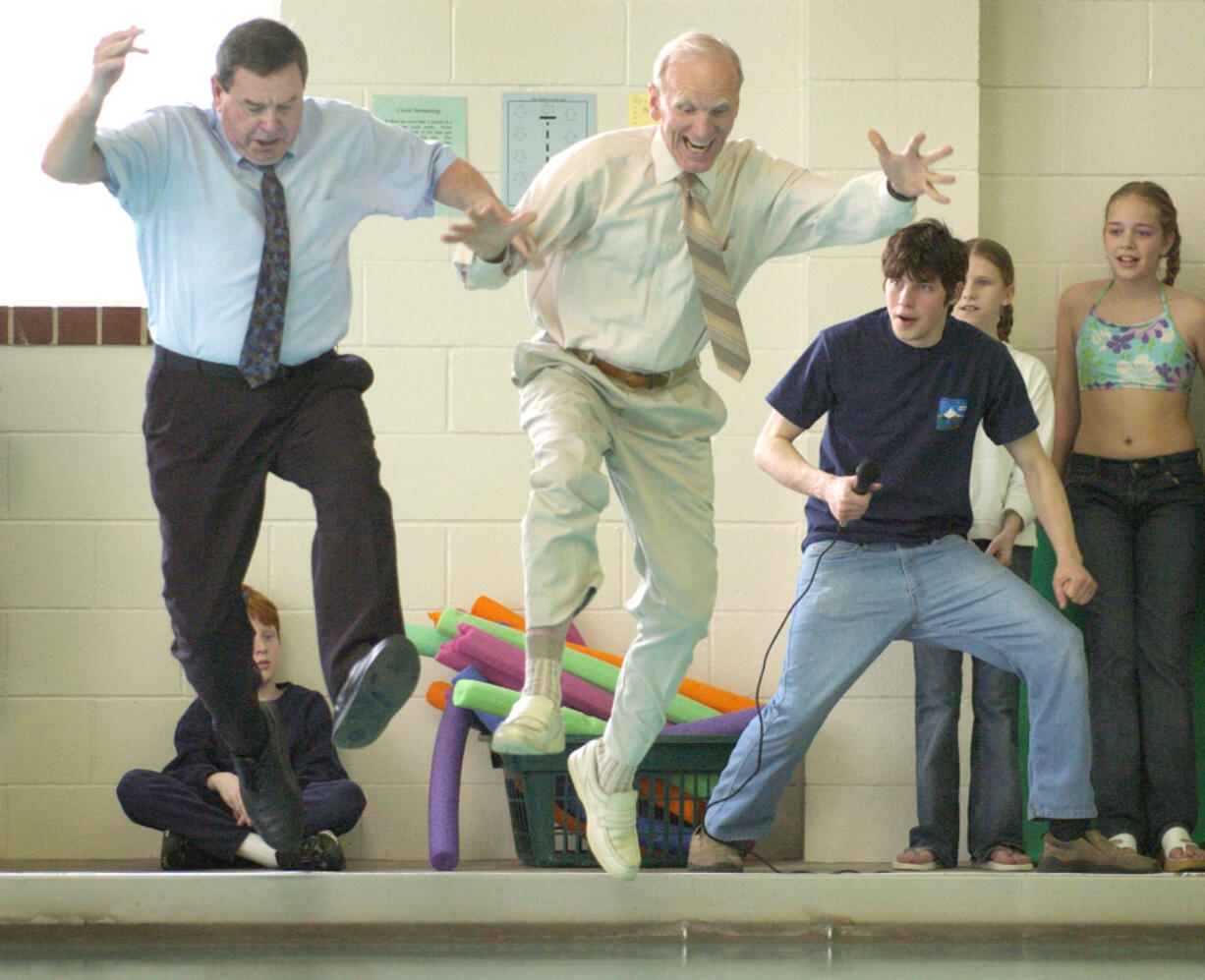 Paul Christensen, center, founder of the Hough Foundation and donor of this swimming pool to the city, leaps in with then Vancouver Mayor Royce Pollard during a 2004 reopening ceremony after a remodel.