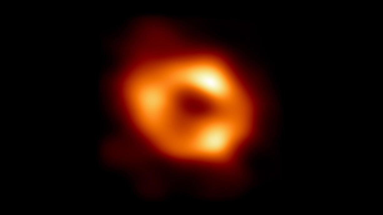 In this handout photo provided by NASA, this is the first image of Sgr A*, the supermassive black hole at the center of our galaxy, with an added black background to fit wider screens. It's the first direct visual evidence of the presence of this black hole. It was captured by the Event Horizon Telescope (EHT), an array that linked together eight existing radio observatories across the planet to form a single Earth-sized virtual telescope.