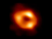 In this handout photo provided by NASA, this is the first image of Sgr A*, the supermassive black hole at the center of our galaxy, with an added black background to fit wider screens. It's the first direct visual evidence of the presence of this black hole. It was captured by the Event Horizon Telescope (EHT), an array that linked together eight existing radio observatories across the planet to form a single Earth-sized virtual telescope.