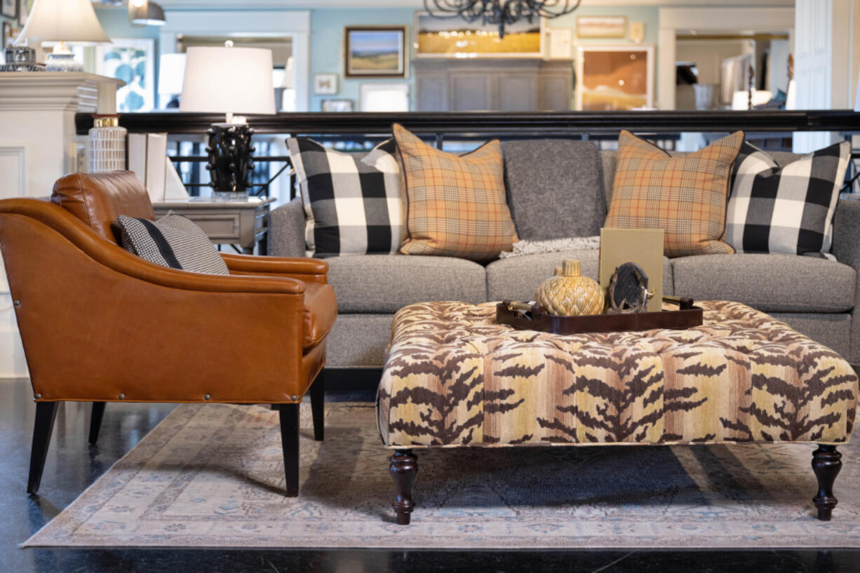 This neutral animal print ottoman shines front and center in this living room design.