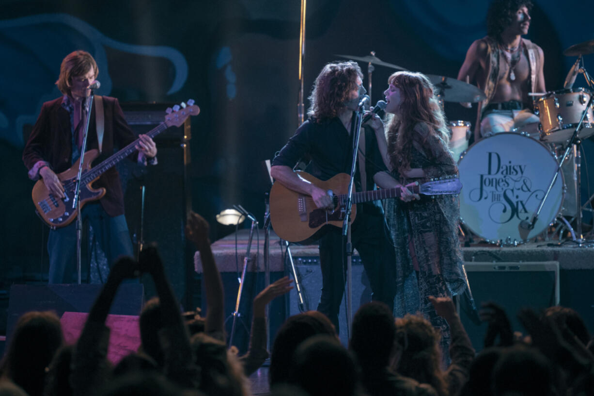 Sam Claflin, center, and Riley Keough perform in "Daisy Jones & The Six." (Lacey Terrell/Prime Video)