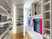 Bins and boxes add to the organization in a primary bedroom closet.