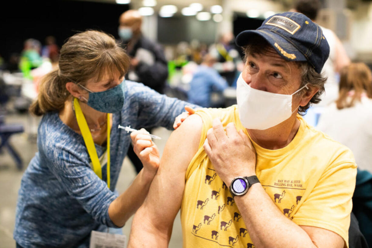 Tim Custer receives his first dose of  the COVID-19 vaccine at Lumen Field Event Center's COVID-19 vaccination site on March 13, 2021. (Matt M.