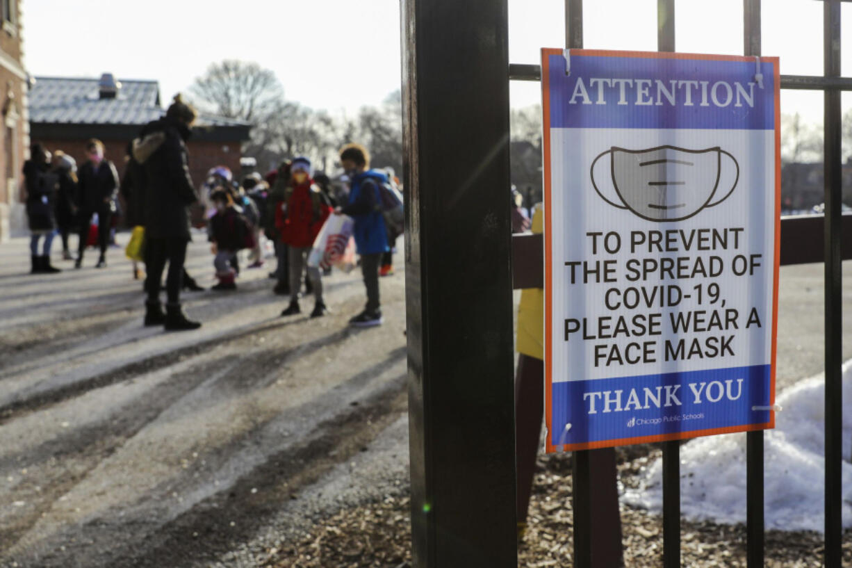 Children from kindergarten to fifth grade arrive for in-person learning at Sutherland Elementary School in Chicago on March 1, 2021, during the COVID-19 pandemic. (Jose M.