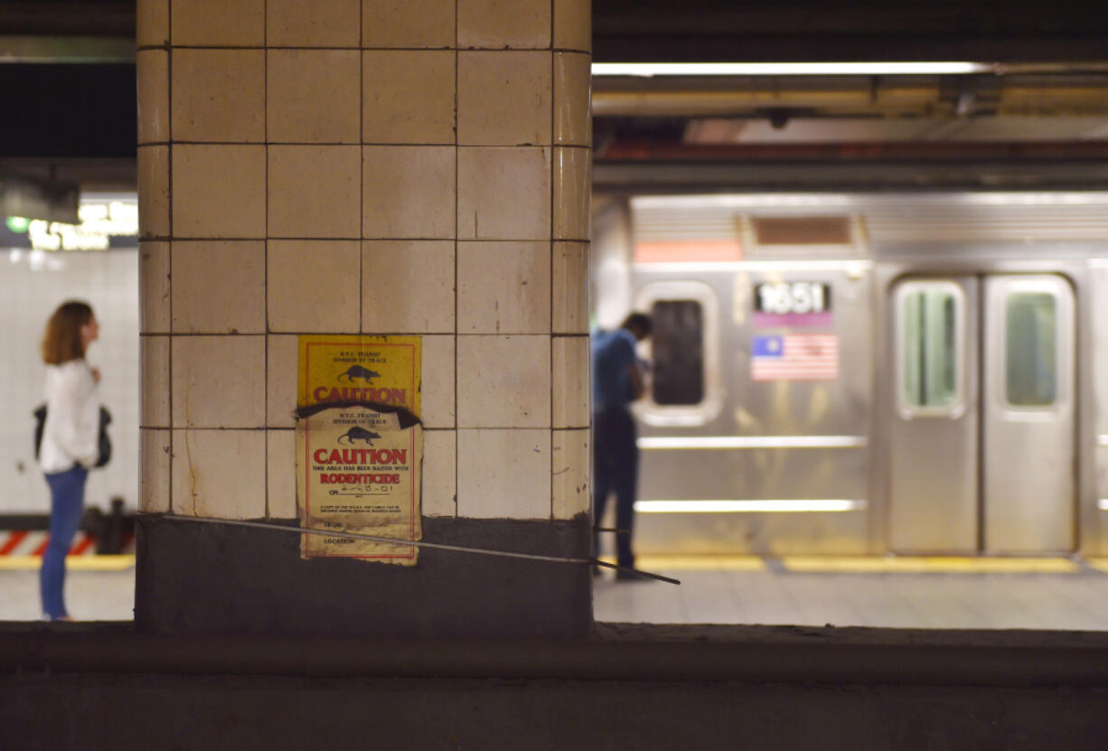 People wait for a train in a subway station, on July 2, 2017 in New York City.