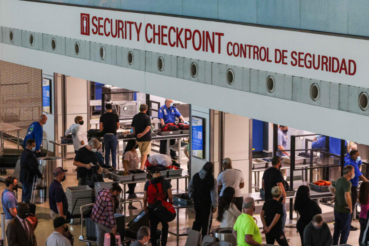 Travelers go through the security checkpoint at the Dallas Love Field airport in Dallas. Biometric technology, such as facial recognition, is increasingly being used in TSA???s identity verification process.