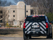 A law enforcement vehicle sits near the Congregation Beth Israel synagogue on Jan. 16, 2022, in Colleyville, Texas. All four people who were held hostage at the Congregation Beth Israel synagogue have been safely released after more than 10 hours of being held captive by a gunman.