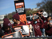 Activists and immigrants rights organizations rally against President Joe Biden's administration asylum policies at the Washington Monument on March 16, 2023, in Washington, D.C.