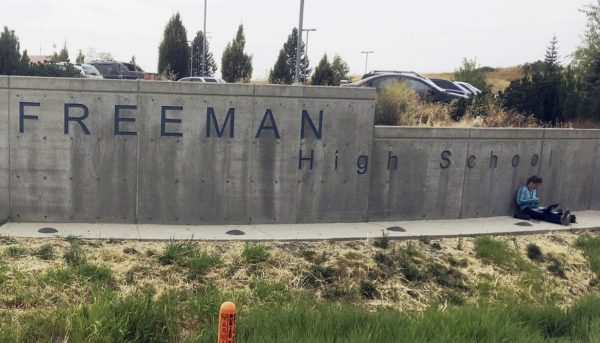 FILE - The sign for Freeman High School in Rockford, Wash., is seen outside the campus on Sept. 13, 2017. A man who shot one classmate to death and wounded three others five years ago in a Washington state high school, apologized to his victims before he was sentenced to 40 years in prison Friday, Aug. 19, 2022. Caleb Sharpe, who was 15 at the time of the 2017 shootings at Freeman High School, pleaded guilty earlier this year in Spokane County Superior Court. (AP Photo/Nicholas K.