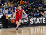 Camas sophomore guard Beckett Currie dribbles during a Class 4A State boys basketball game on Wednesday, March 1, 2023, at the Tacoma Dome.