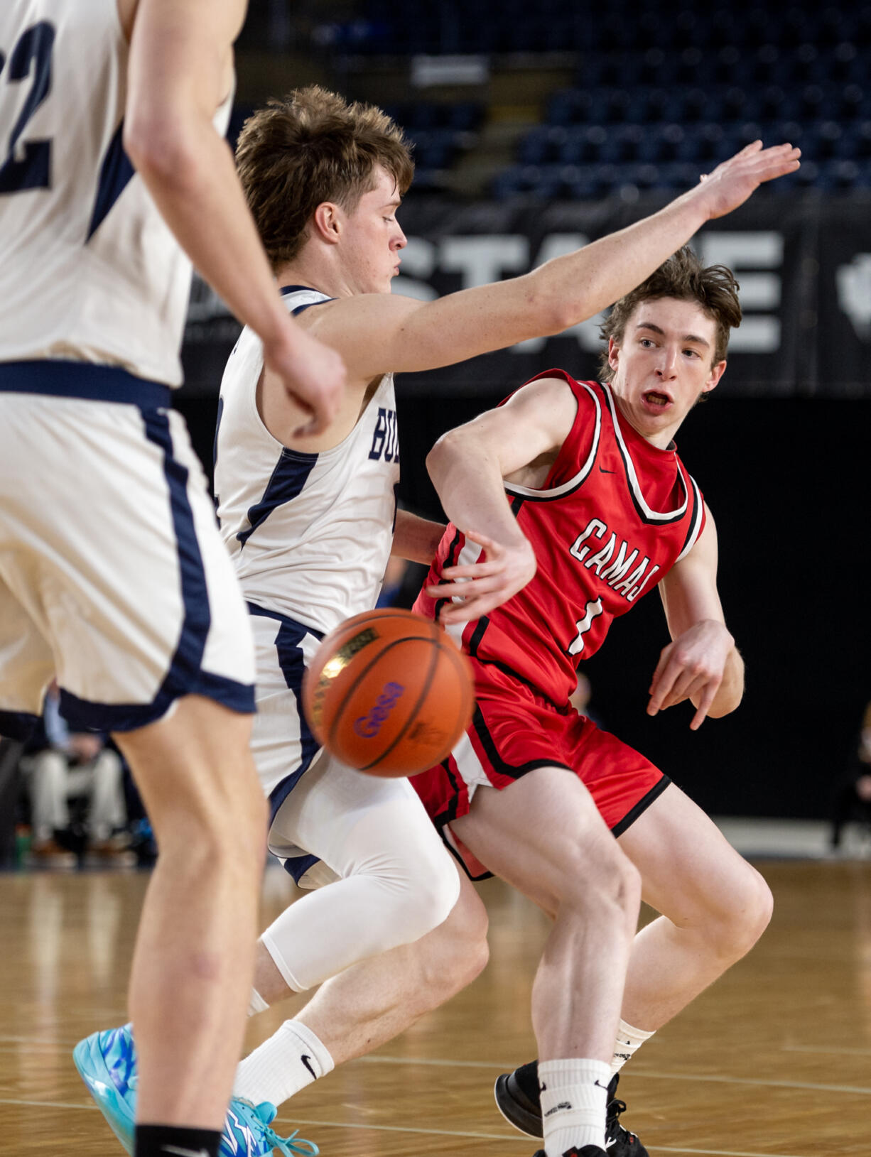 Camas guard Beckett Currie delivers a pass in between Gonzaga Prep defenders during a Class 4A State boys basketball trophy game on Saturday, March 4, 2023, at the Tacoma Dome.