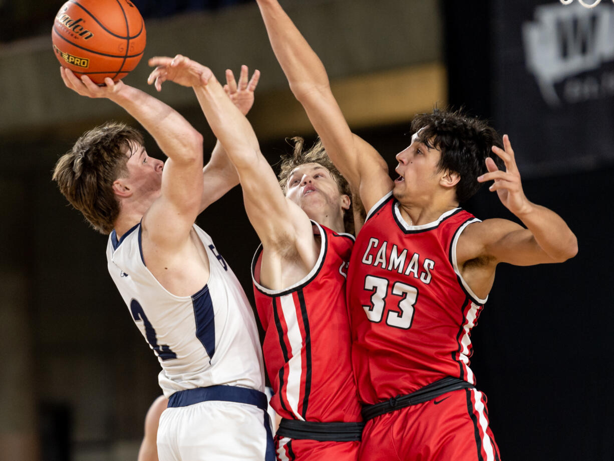 Gonzaga Prep senior guard Jackson Floyd tries to get off a shot against the defense of Camas senior forward Josh Dabasinskas and Camas senior forward Jamison Carlisle during a Class 4A State boys basketball trophy game on Saturday, March 4, 2023, at the Tacoma Dome.