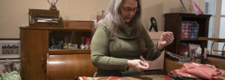 Miki Landis repairs a frayed section of quilt at her sewing store, The Enchanted Rose Emporium. She teaches a variety of workshops to help people get comfortable with basic repairs.