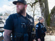 Vancouver police Sgt. James Kelly, left, and Cpl. Jamie Haske stand outside the department's West Precinct wearing Axon body cameras. The officers said the biggest learning curve since receiving the cameras two weeks ago has been remembering to activate the recording before responding to calls.