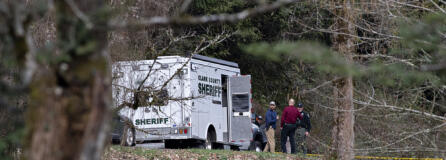 Law enforcement officials work at the scene along Wooding Road east of Washougal on Wednesday afternoon, March 22, 2023. Authorities found two bodies believed to be those of a missing Vancouver woman and her 7-year-old daughter in a brushy area farther down Wooding Road.