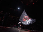 Blaze the Trail Cat waves a flag around the court Friday, March 31, 2023, before the Blazers’ 138-114 loss to the Kings at Moda Center.