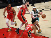 Portland shooting guard Keon Johnson, right, drives to the basket Monday, March 27, 2023, during the Trail Blazers’ 124-90 loss to the Pelicans at Moda Center.