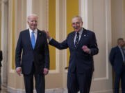 President Joe Biden, left, and Senate Majority Leader Chuck Schumer, D-N.Y., talk to reporters after a lunch with Senate Democrats on his upcoming budget and political agenda, at the Capitol in Washington, Thursday, March 2, 2023. (AP Photo/J.