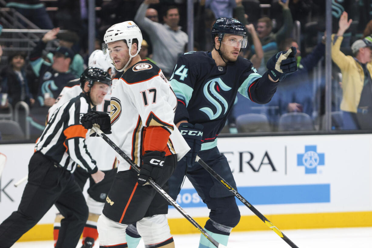 Seattle Kraken defenseman Jamie Oleksiak, right, celebrates his goal as Anaheim Ducks defenseman Scott Harrington looks on during the first period of an NHL hockey game Tuesday, March 7, 2023, in Seattle.