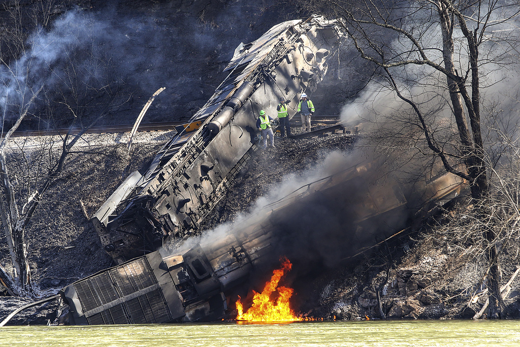 Smoke fills the sky after an empty CSX coal train hit a rockslide along tracks causing a fiery derailment on Wednesday, March 8, 2023 in a remote area just south of Sandstone, W.Va.  Four locomotives and 22 empty cars derailed in Summers County near the New River, CSX said. The lead locomotive, which carried a conductor, an engineer and an engineer trainee, caught fire and the crewmembers were being evaluated and treated for non-life threatening injuries, the company said.