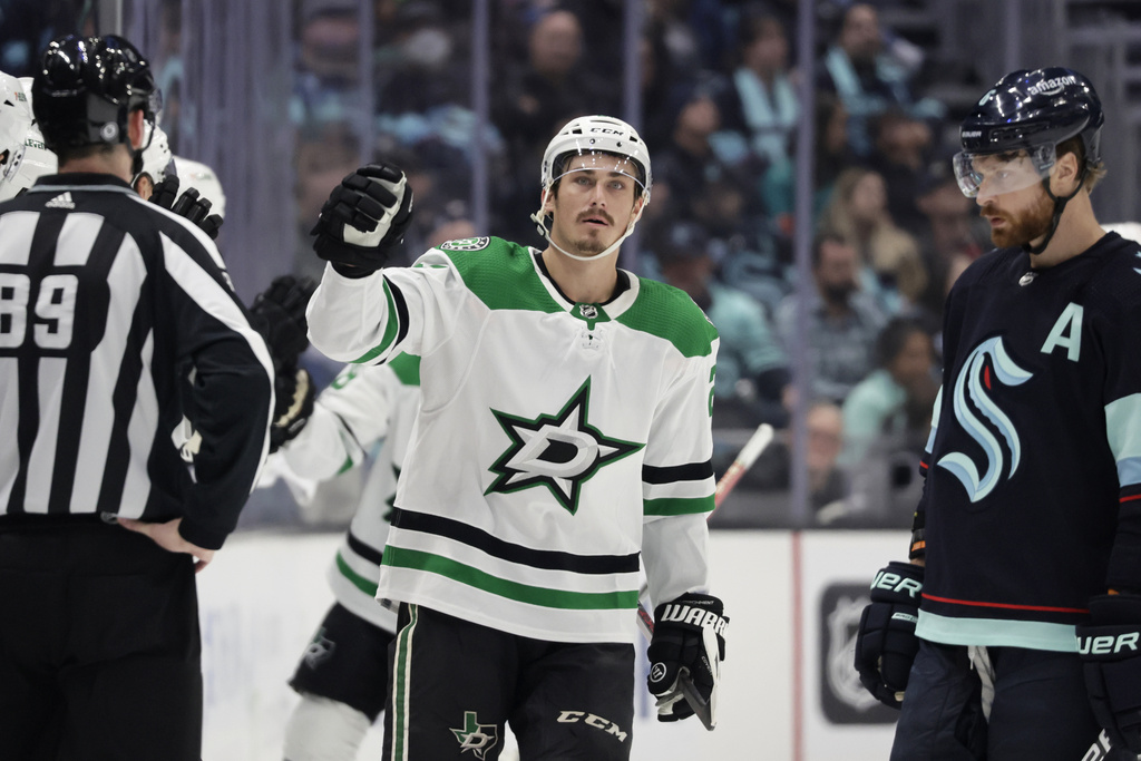 Dallas Stars left wing Mason Marchment, center, celebrates after his goal as Seattle Kraken defenseman Adam Larsson (6) looks on during the second period of an NHL hockey game, Saturday, March 11, 2023, in Seattle.