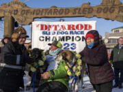 Ryan Redington poses with his lead dogs Sven, left, and Ghost, after he won the 2023 Iditarod Trail Sled Dog Race Tuesday, March 14, 2023 in Nome, Alaska.