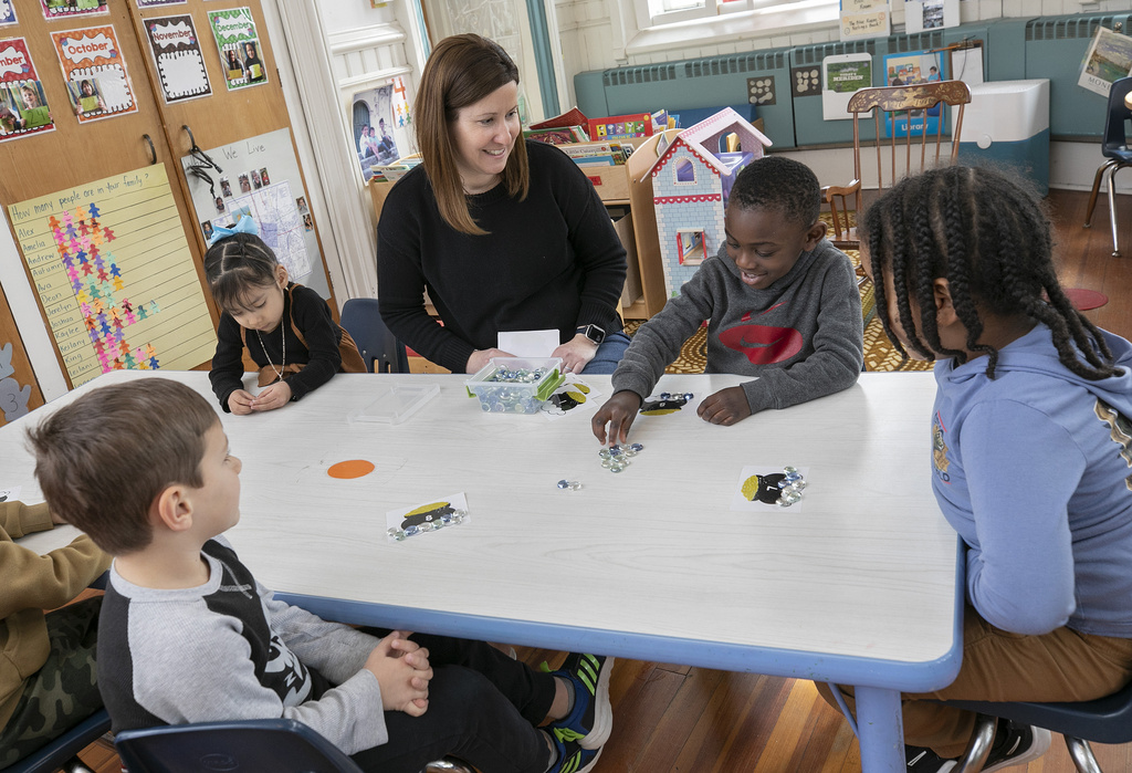 Oliver Larbi, 3, of Meriden, Conn., counts out chips next to teacher Michelle Tommell during a literacy and math skills small group activity at First Congregational Preschool at 62 Colony St. in Meriden, Conn., Thursday, March 16, 2023. First Congregational Preschool is one of the ten child care services in Meriden that is part of the state's School Readiness Program.