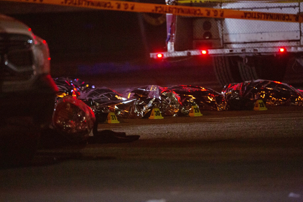 The bodies of dead migrants are covered with "space blankets" in the parking lot of a Mexican immigration detention center where doezens of migrants died after a fire broke out at a Mexican immigration detention center in Juarez on Monday, March 27, 2023. A fire in a dormitory at a Mexican immigration detention center near the U.S. border left more than three dozen migrants dead. It was one of the deadliest incidents ever at an immigration lockup in the country.