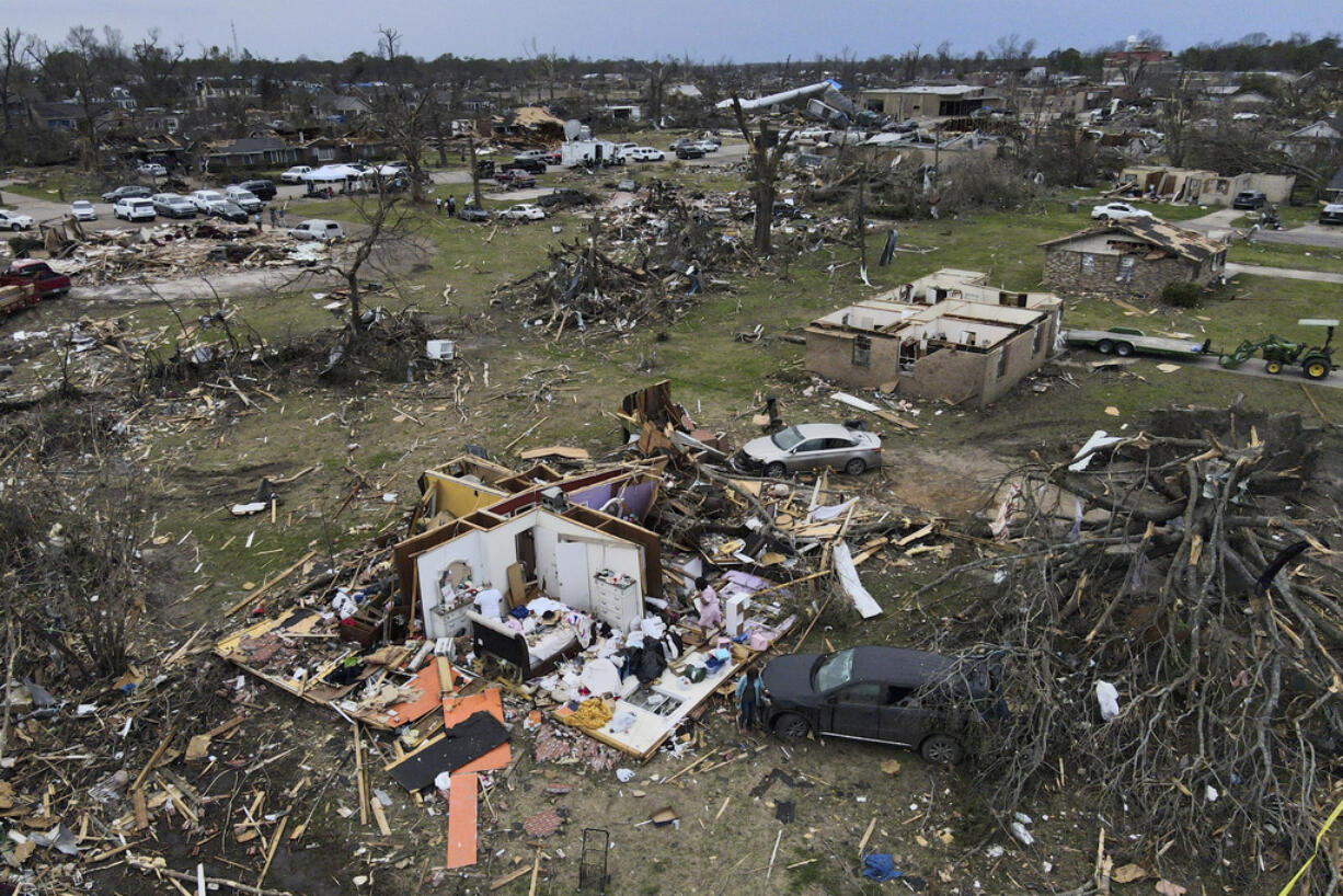 FILE - Debris is strewn about tornado damaged homes, Sunday, March 26, 2023, in Rolling Fork, Miss. Meteorologists are urging people in parts of the Midwest and southern U.S. to be ready Friday, March 31, for dangerous weather including tornadoes, saying the conditions are similar to those a week ago that unleashed a devastating twister that killed at least 21 people in Mississippi.