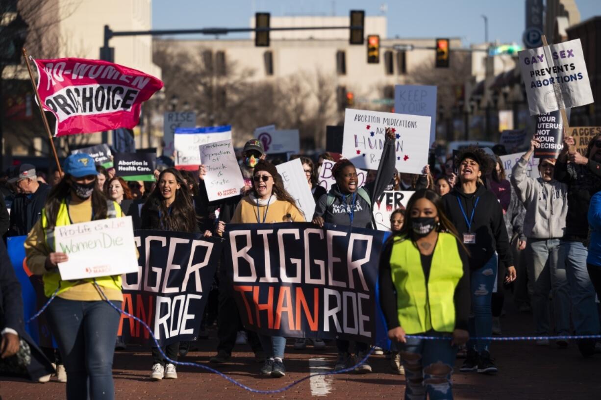 FILE - People march through downtown Amarillo to protest a lawsuit to ban the abortion drug mifepristone on Feb. 11, 2023, in Amarillo, Texas. A federal judge will hear arguments Wednesday, March 15, 2023, in a high-stakes court case that could threaten access to abortion medication and blunt the authority of U.S. drug regulators.