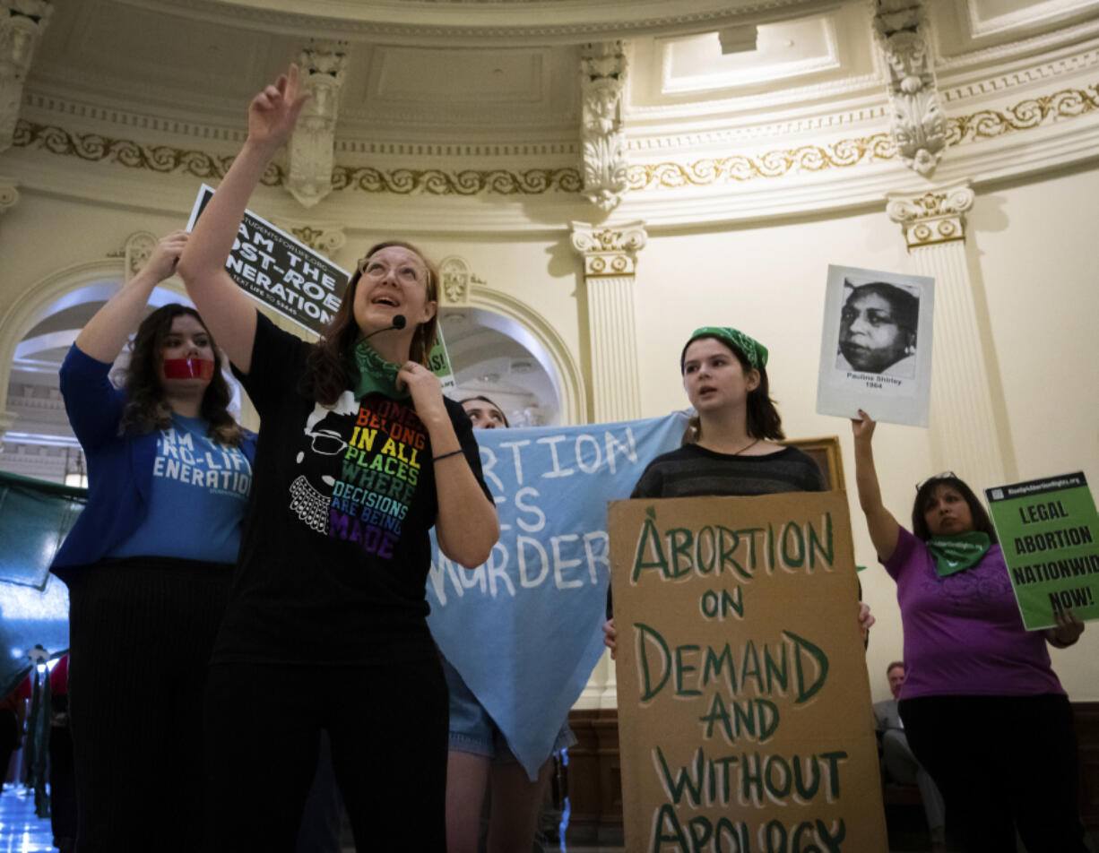 Sarah Bentley, second from left, leads songs at an International Women's Day Sit-In for Abortion Rights in the Texas State Capitol Rotunda, Wednesday, March 8, 2023, in Austin, Texas. Both abortion rights and anti-abortion protesters were present on the rotunda, speaking to curious passers-by, singing songs and occasionally chanting.