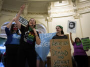 Sarah Bentley, second from left, leads songs at an International Women's Day Sit-In for Abortion Rights in the Texas State Capitol Rotunda, Wednesday, March 8, 2023, in Austin, Texas. Both abortion rights and anti-abortion protesters were present on the rotunda, speaking to curious passers-by, singing songs and occasionally chanting.