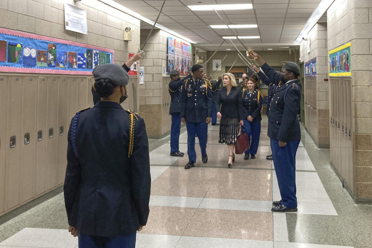 Army Secretary Christine Wormuth is greeted at the Chicago Military Academy as she heads into meetings with young members of the Reserve Officers' Training Corps in Chicago, on Feb. 15, 2023. Army recruiters are struggling to meet enlistment goals, and they say one of their biggest hurdles is getting back into high schools so they can meet students one on one. During three days of back-to-back meetings across Chicago last month, Wormuth met with students, school leaders, college heads, recruiters and an array of young people involved in ROTC or JROTC programs.