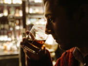 Bourbon aficionado Cody Walding from Houston, Texas, tastes a 10-year old bourbon by Eagle Rare at the Seven Grand bar, a whiskey bar downtown Los Angeles Tuesday, Feb. 28, 2023. Seven Grand offers an extensive selection of over 700 different whiskies from around the world, including rare and hard-to-find bottles.