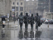 Snow falls around the statue of the British group The Beatles, at Pier Head in Liverpool, England, Thursday March 9, 2023. The UK is set to experience severe snowstorms and travel disruption as the Met Office has issued an amber warning in some areas.